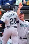 Seattle Mariners manager Scott Servais, right, congratulates Taylor Trammell after Trammell hit a solo home run during the ninth inning in the first baseball game of a doubleheader against the Chicago White Sox in Chicago, Sunday, June 27, 2021. (AP Photo/Nam Y. Huh)