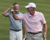 Jerry Kelly, left, watches as Steve Stricker celebrates his win at the Bridgestone Senior Players Championship golf tournament at Firestone Country Club on Sunday, June 27, 2021, in Akron, Ohio. (Mike Cardew/Akron Beacon Journal via AP)