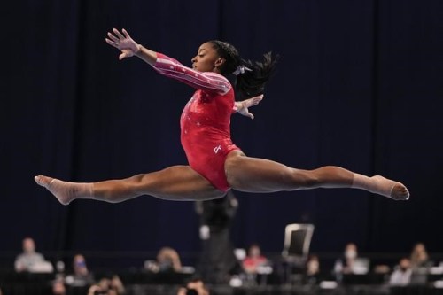 Simone Biles competes in the floor exercise during the women's U.S. Olympic Gymnastics Trials Sunday, June 27, 2021, in St. Louis. (AP Photo/Jeff Roberson)