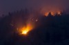 Flare-ups are seen from the Christie Mountain wildfire along Skaha Lake in Penticton, B.C. Thursday, Aug. 20, 2020.THE CANADIAN PRESS/Jonathan Hayward