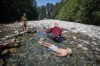 Albert Huynh cools off in the frigid Lynn Creek water as Leanne Opuyes, left, laughs in North Vancouver, B.C., on Monday, June 28, 2021. A stifling heat wave throughout much of Western Canada is unusual because of the nighttime temperatures it is bringing, says an expert. THE CANADIAN PRESS/Darryl Dyck