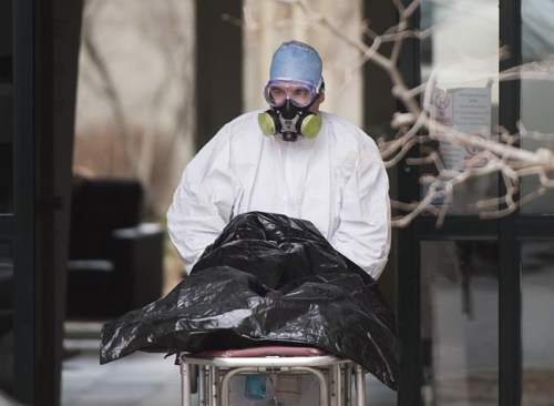 A body is removed from Residence Herron, a long-term care home in Dorval, Que., Saturday, April 11, 2020. A new study suggests Canada has vastly underestimated how many people have died from COVID-19 and says the number could be two times higher than reported. THE CANADIAN PRESS/Graham Hughes