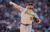 Pittsburgh Pirates relief pitcher Clay Holmes turns to make a pickoff throw against the Colorado Rockies in the sixth inning of a baseball game Monday, June 28, 2021, in Denver. (AP Photo/David Zalubowski)