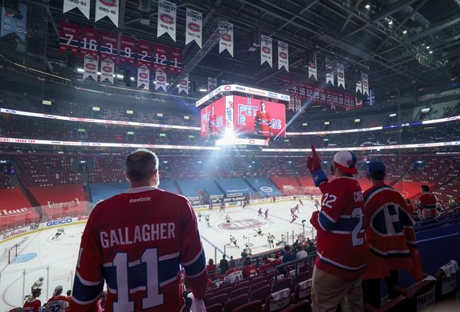Fans cheer on their team during the pre-game warmup of Game 3 of the NHL Stanley Cup semifinal with the Montreal Canadiens facing the Vegas Golden Knights Friday, June 18, 2021 in Montreal. The Montreal Canadiens say they're asking the provincial government for permission to allow 10,500 fans to attend upcoming games in Montreal, up from 3,500. THE CANADIAN PRESS/Paul Chiasson