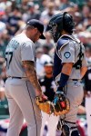 Seattle Mariners catcher Luis Torrens, right, talks with relief pitcher Hector Santiago during the fifth inning in the first baseball game of a doubleheader against the Chicago White Sox in Chicago, Sunday, June 27, 2021. (AP Photo/Nam Y. Huh)