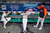 Detroit Tigers' Akil Baddoo, left to right, Derek Holland and Willi Castro talk during a rain delay before a baseball game against the Cleveland Indians, Tuesday, June 29, 2021, in Cleveland. (AP Photo/Tony Dejak)