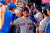 New York Mets' James McCann (33) celebrates in the dugout after hitting a three-run home run during the seventh inning of the team's baseball game against the Atlanta Braves on Tuesday, June 29, 2021 in Atlanta. (AP Photo/John Bazemore)