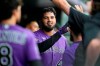 Colorado Rockies starting pitcher German Marquez is congratulated after he scored on a single by Charlie Blackmon off Pittsburgh Pirates starting pitcher Chase De Jong in the fifth inning of a baseball game Tuesday, June 29, 2021, in Denver. (AP Photo/David Zalubowski)