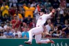 Boston Red Sox's Alex Verdugo goes airborne while heading home to score on a two-run double by J.D. Martinez during the sixth inning of the team's baseball game against the Kansas City Royals at Fenway Park, Tuesday, June 29, 2021, in Boston. (AP Photo/Charles Krupa)