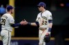 Milwaukee Brewers' Christian Yelich (22) shakes hands with Daniel Robertson (28) after the team's baseball game against the Chicago Cubs on Tuesday, June 29, 2021, in Milwaukee. (AP Photo/Aaron Gash)