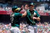 Oakland Athletics' Elvis Andrus, left, celebrates with Matt Olson after they scored on Matt Chapman's two-run single during the first inning of a baseball game against the San Francisco Giants in San Francisco, Sunday, June 27, 2021. (AP Photo/Jeff Chiu)