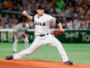 FILE - In this March 14, 2017, file photo, Japan starting pitcher Tomoyuki Sugano throws to a Cuba batter during the first inning of a second-round game at the World Baseball Classic in Tokyo. Host Japan is favored to win at the Tokyo Games. . Right-hander Tomoyuki Sugano, the reigning Central League MVP, heads a pitching staff that includes current Rookies of the Year Masato Morishita and Kaima Taira. (AP Photo/Toru Takahashi, File)