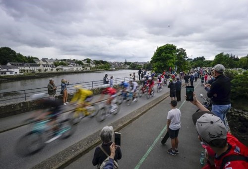 The pack with Netherland's Mathieu Van Der Poel, wearing the overall leader's yellow jersey, rides during the third stage of the Tour de France cycling race over 182.9 kilometers (113.65 miles) with start in Lorient and finish in Pontivy, France, Monday, June 28, 2021. (AP Photo/Daniel Cole)