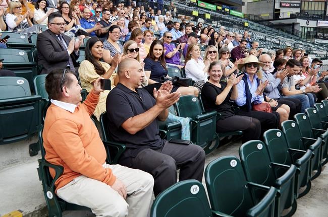 Hector Calderon, Oregon's first COVID-19 patient, second from left, is applauded during an event announcing the end of the state's COVID-19 restrictions in Portland, Ore., Wednesday, June 30, 2021. (AP Photo/Craig Mitchelldyer)