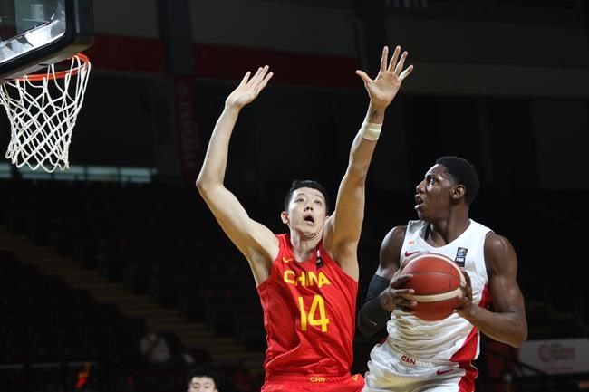 Canada's RJ Barrett looks to shoot past China's Zijie Shen during the first half of FIBA Men's Olympic Qualifying basketball action at Memorial Arena in Victoria, B.C., on Wednesday, June 30, 2021. THE CANADIAN PRESS/Chad Hipolito