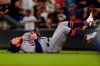 New York Mets second baseman Travis Blankenhorn falls after catching a fly ball from Atlanta Braves' Ronald Acuna Jr. duirng the sixth inning of a baseball game Wednesday, June 30, 2021, in Atlanta. (AP Photo/John Bazemore)