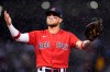 Boston Red Sox first baseman Michael Chavis gestures to fans as rain falls during the fifth inning of the team's baseball game against the Kansas City Royals at Fenway Park, Wednesday, June 30, 2021, in Boston. (AP Photo/Elise Amendola)