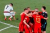 Belgium players celebrate winning 1-0 as Portugal's Cristiano Ronaldo, 7, reacts after the Euro 2020 soccer championship round of 16 match between Belgium and Portugal at La Cartuja stadium in Seville, Spain, Sunday, June 27, 2021. (Jose Manuel Vidal/Pool via AP)