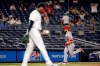 Los Angeles Angels' Jared Walsh rounds third base after hitting a grand slam off of New York Yankees relief pitcher Aroldis Chapman, foreground, during the ninth inning of a baseball game early Thursday, July 1, 2021, in New York. (AP Photo/Adam Hunger)
