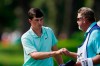 Davis Thompson fist bumps his caddie after finishing his round on the ninth green during the first round of the Rocket Mortgage Classic golf tournament, Thursday, July 1, 2021, at the Detroit Golf Club in Detroit. (AP Photo/Carlos Osorio)