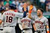 Houston Astros' Jose Altuve (27) is congratulated by Jason Castro (18) after Altuve hit a grand slam in the fifth inning of a baseball game against the Cleveland Indians, Thursday, July 1, 2021, in Cleveland. (AP Photo/Tony Dejak)