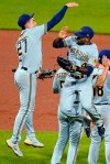 Milwaukee Brewers' Jackie Bradley Jr., right, celebrates with Willy Adames (27) after the team's 7-2 win over the Pittsburgh Pirates in a baseball game in Pittsburgh, Thursday, July 1, 2021. (AP Photo/Gene J. Puskar)