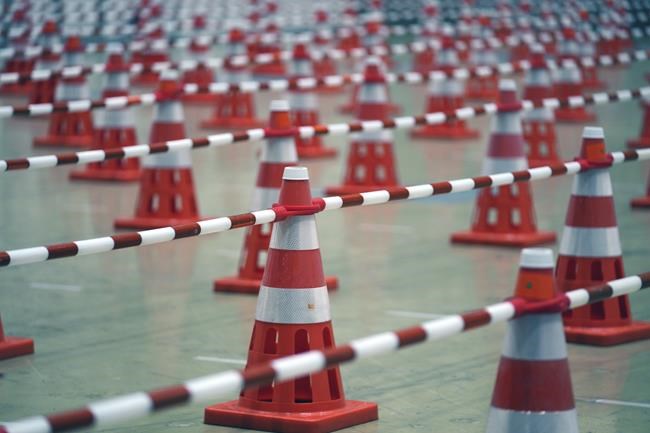 Lines for PCR sample collection room are seen at Main Press Center (MPC) for Tokyo 2020 Olympic Games at Tokyo Big Site Friday, July 2, 2021, in Tokyo. (AP Photo/Eugene Hoshiko)