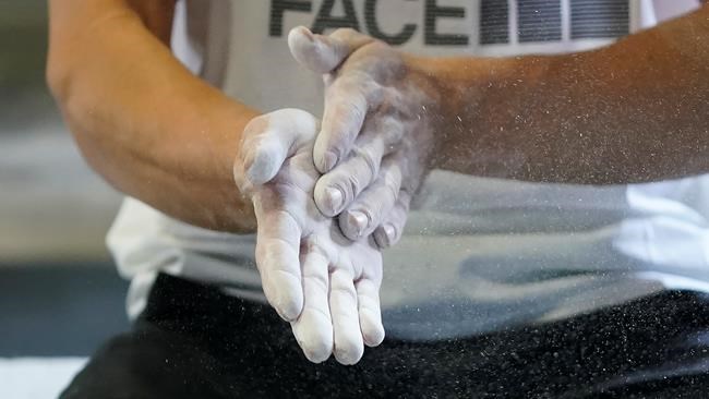 Nathaniel Coleman rubs his hands before climbing during practice on Wednesday, May 26, 2021, in Salt Lake City.