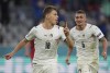 Italy's Nicolo Barella, left, and Italy's Marco Verratti celebrate scoring the opening goal during the Euro 2020 soccer championship quarterfinal match between Belgium and Italy at the Allianz Arena stadium in Munich, Germany, Friday, July 2, 2021. (AP Photo/Matthias Schrader, Pool)