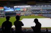 Fans wait for the rain to stop before a baseball game between the New York Yankees and the New York Mets at Yankee Stadium, Friday, July 2, 2021, in New York. (AP Photo/Frank Franklin II)