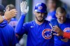 Chicago Cubs' Kris Bryant high-fives teammates after scoring a run during the fourth inning of the team's baseball game against the Cincinnati Reds in Cincinnati, Friday, July 2, 2021. (AP Photo/Aaron Doster)