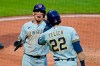 Milwaukee Brewers' Willy Adames, left, and Christian Yelich (22) celebrate after scoring on a triple by Tyrone Taylor off Pittsburgh Pirates starting pitcher JT Brubaker during the sixth inning of a baseball game in Pittsburgh, Friday, July 2, 2021. (AP Photo/Gene J. Puskar)