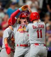 St. Louis Cardinals' Harrison Bader, center, celebrates his three-run home run with Paul DeJong during the 10th inning of the team's baseball game against the Colorado Rockies on Friday, July 2, 2021, in Denver. The Cardinals won 9-3. (AP Photo/David Zalubowski)