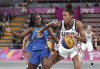 FILE - In this July 29, 2019, file photo, Olivia Nelson, right, of the United States, drives around Evelyn Mariano, of Brazil, during the women's basketball 3x3 semifinal match at the Pan American Games in Lima, Peru. The Olympics website calls 3x3 basketball “exciting, urban and innovative.” It was added to the program for Tokyo to lure a younger audience and get more countries involved in one of the core sports of the Olympic Games. (AP Photo/Martin Mejia, File)