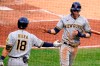 Milwaukee Brewers' Christian Yelich, right, celebrates with Keston Hiura after scoring on a single by Milwaukee Brewers' Jace Peterson during the sixth inning of a baseball game against the Pittsburgh Pirates in Pittsburgh, Saturday, July 3, 2021. (AP Photo/Gene J. Puskar)