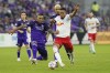 Orlando City defender Antonio Carlos, left, tries to stop New York Red Bulls forward Fabio, right front, from advancing the ball during the first half of an MLS soccer match Saturday, July 3, 2021, in Orlando, Fla. (AP Photo/John Raoux)