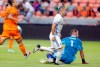FC Cincinnati forward Alvaro Barreal, middle, and Houston Dynamo goalkeeper Marko Maric (1) watch Barreal's goal go into the net as Sam Junqua, left, closes in on the play during the first half of an MLS soccer match Saturday, July 3, 2021, in Houston. (AP Photo/Michael Wyke)