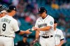 Seattle Mariners starting pitcher Marco Gonzales, right, hands the baseball to manager Scott Servais as he leaves during the fourth inning against the Texas Rangers on Saturday, July 3, 2021, in Seattle. (AP Photo/Elaine Thompson)