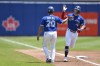 Toronto Blue Jays' Randal Grichuk, right, is congratulated by third base coach Luis Rivera after hitting a solo home run against the Tampa Bay Rays during the second inning of a baseball game in Buffalo, N.Y., Sunday, July 4, 2021. (AP Photo/Adrian Kraus)