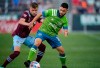 Seattle Sounders midfielder Alex Roldan, right, battles for control of the ball with Colorado Rapids defender Sam Vines in the first half of an MLS soccer match, Sunday, July 4, 2021, in Commerce City, Colo. (AP Photo/David Zalubowski)