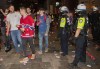 Police officers keep an eye on Montreal Canadiens fans following game 3 of the NHL Stanley Cup final between the Canadiens and the Tampa Bay Lightning outside the Bell Centre in Montreal, Friday, July 2, 2021. THE CANADIAN PRESS/Graham Hughes