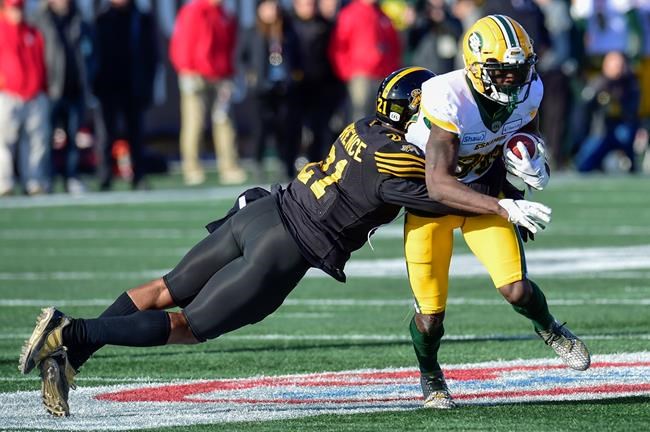 Hamilton Tiger-Cats linebacker Simoni Lawrence (21) tackles Edmonton Eskimos wide receiver DaVaris Daniels (80) during first half CFL East Final football action in Hamilton, Ont., on November 17, 2019. THE CANADIAN PRESS/Frank Gunn