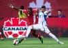Canada's Doneil Henry, left, and El Salvador's Nelson Bonilla vie for the ball during first half FIFA World Cup qualifying soccer action in Vancouver, B.C., on Tuesday Sept. 6, 2016. The city of Montreal says it is withdrawing its candidacy for host city for FIFA World Cup 2026. THE CANADIAN PRESS/Darryl Dyck