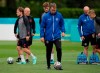 Denmark's coach Kasper Hjulmand, center, walks with the ball during a team training session at Tottenham Hotspur training ground in London, Tuesday, July 6, 2021 ahead of their Euro 2020 soccer championship semifinal match against England at Wembley Stadium on Wednesday. (AP Photo/Thanassis Stavrakis)