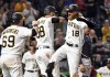 Pittsburgh Pirates' John Nogowski, left, and Jacob Stallings, second from left, congratulate Ben Gamel (18) after Gamel hit a three-run home run against the Atlanta Braves in the seventh inning of a baseball game Monday, July 5, 2021, in Pittsburgh. (Matt Freed/Pittsburgh Post-Gazette via AP)