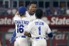 Kansas City Royals' Salvador Perez, center, celebrates with Andrew Benintendi and Jarrod Dyson after hitting a walk-off single in the ninth inning of a baseball game against the Cincinnati Reds Tuesday, July 6, 2021, in Kansas City, Mo. The Royals won 7-6. (AP Photo/Charlie Riedel)