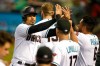 Arizona Diamondbacks' Eduardo Escobar, left, is congratulated by manager Torey Lovullo (17) and David Peralta (6) after scoring a run against the Colorado Rockies on a double by Christian Walker during the first inning of a baseball game, Tuesday, July 6, 2021, in Phoenix. (AP Photo/Ralph Freso)