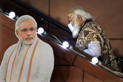 FILE - In this Nov. 11 2020, file photo, Indian Prime Minister Narendra Modi leaves after a function at the Bharatiya Janata Party headquarters following a state election in New Delhi, India. Twelve Indian government ministers resigned Wednesday, hours ahead of an expected reshuffle of Prime Minister Narendra Modi's Cabinet aimed at refurbishing its image after widespread criticism of its handling of the COVID-19 pandemic. (AP Photo/Manish Swarup, File)