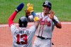 Atlanta Braves' Ehire Adrianza, right, celebrates with Ronald Acuna Jr. after both scored on an RBI single by Orlando Arcia off Pittsburgh Pirates relief pitcher Chasen Shreve during the sixth inning of a baseball game in Pittsburgh, Wednesday, July 7, 2021. (AP Photo/Gene J. Puskar)