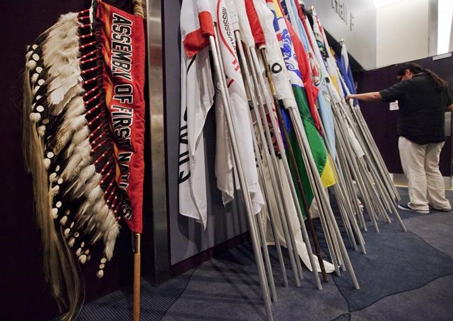 Flags from communities across the country are piled together as the Assembly of First Nations Annual General Assembly comes to an end in Toronto on Thursday, July 19, 2012. THE CANADIAN PRESS/Michelle Siu